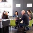 A group of people working at a table during the RGD's Designathon
