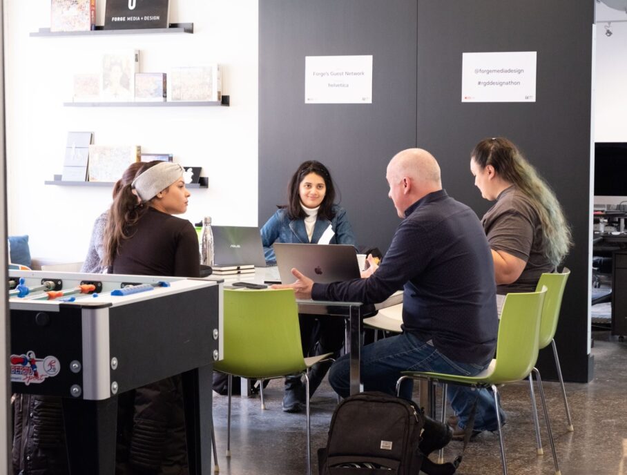 A group of people working at a table during the RGD's Designathon