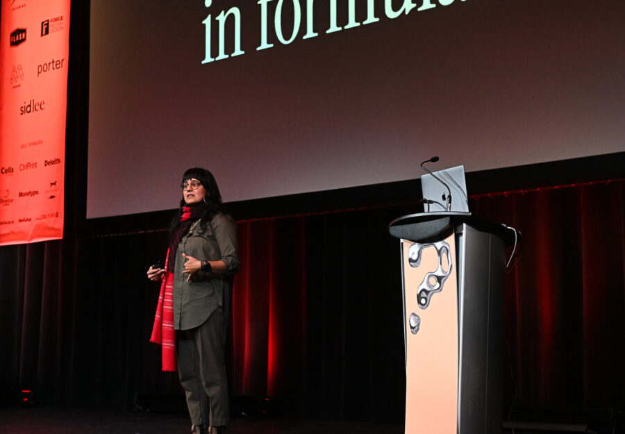 Image of Nishat Akhtar on stage presenting