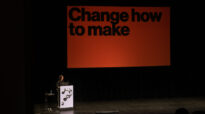 Liza Enebeis presenting on stage with slide saying Change how to make